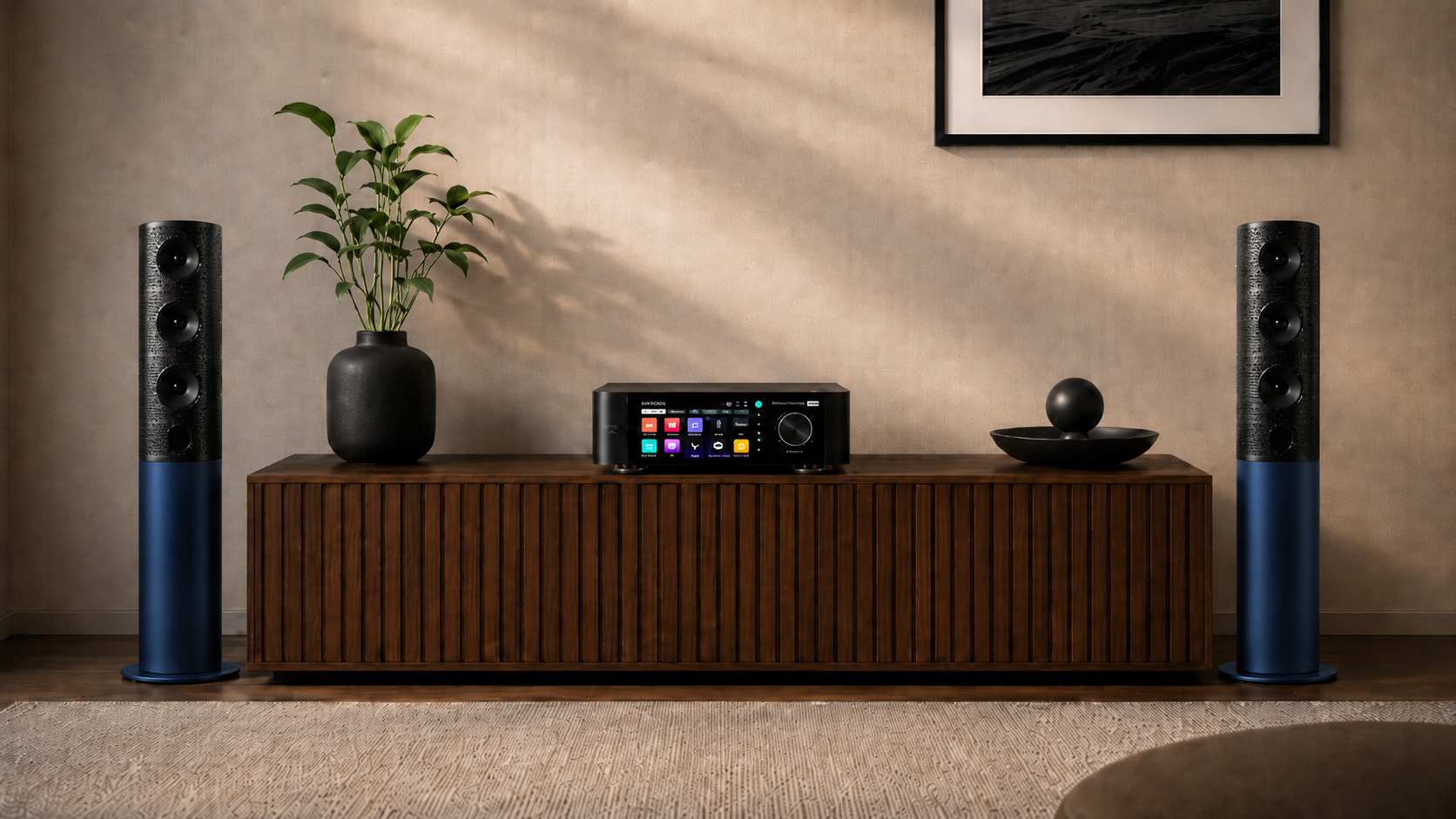 Audio equipment including speakers and a receiver on a wooden cabinet against a beige wall.